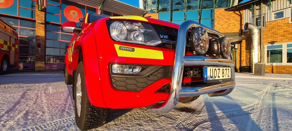 Red command vehicle with bull bar in front of Karlstad fire station in winter