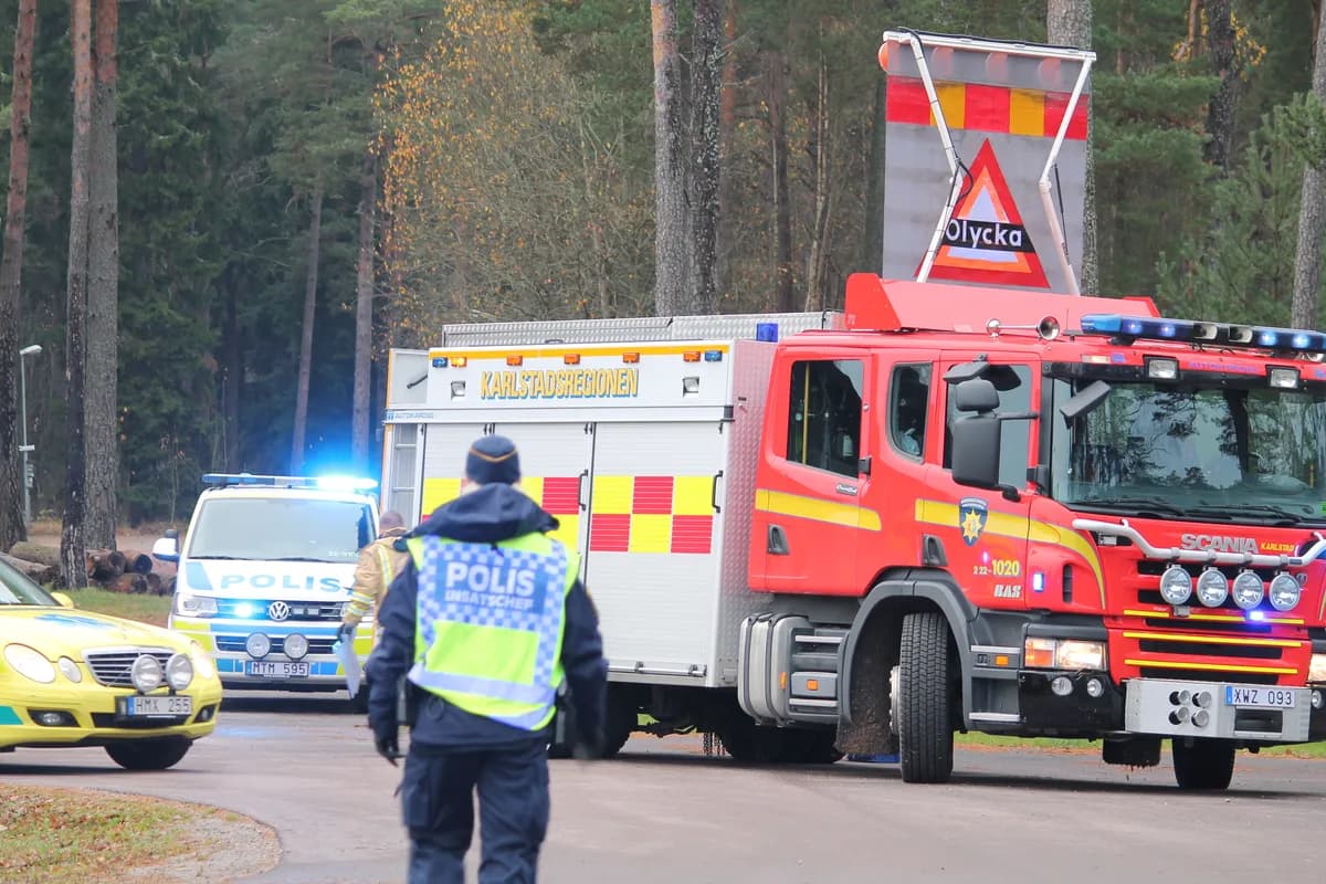 Police officer from behind at fire truck and emergency vehicles during operation