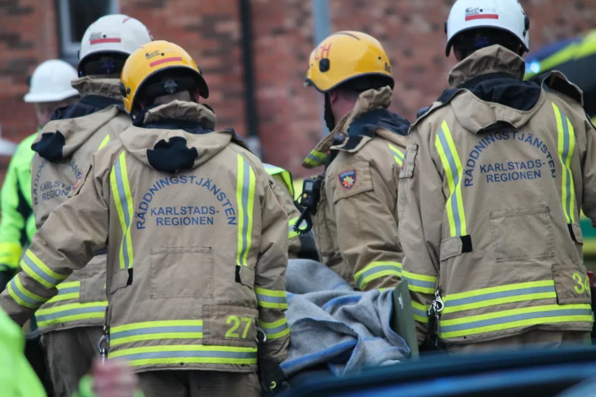 Firefighters from behind carrying stretcher at rescue operation